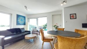 a living room with a couch and a table at Dinkelbach Feriendomicil 2 D in Lindau-Bodolz