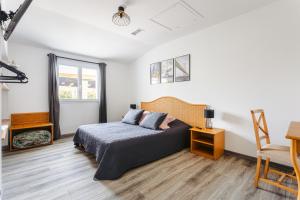 ein Schlafzimmer mit einem Bett und einem Stuhl in der Unterkunft Gîte Panda in Marans + 18 Fotos