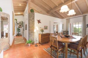 a dining room and living room with a table and chairs at Casa Alecrim - Selão da Eira in Pedreneiras