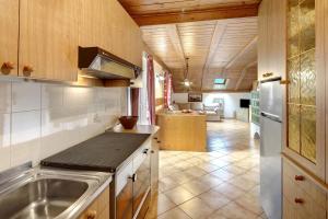 a kitchen with a sink and a refrigerator at Mansarda Maema in Moena +17 photos