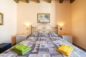 a bedroom with a large bed with two night stands at Da Giò, a due passi dal mare in Calasetta
