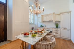a kitchen with a table with fruits and vegetables on it at Maison Mirò with private parking in Lucca +12 photos