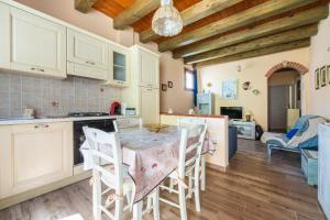 a kitchen and dining room with a table and chairs at Da Giò, a due passi dal mare in Calasetta +14 photos