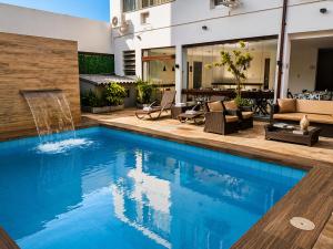 a swimming pool with a fountain in a house at REF House Barra Da Tijuca in Rio de Janeiro