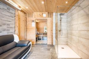 a bathroom with a couch and a shower at Chalet - Le crey rond in Valloire +24 photos