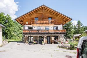a large wooden house with a wrap around deck at Chalet - Le crey rond in Valloire
