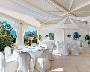 a white tent with white tables and white chairs at Villa Pia in Uta +46 photos