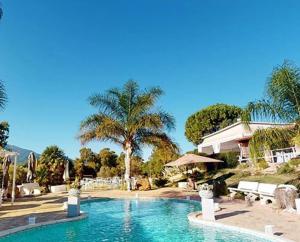 a swimming pool in front of a house at Villa Pia in Uta
