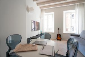 a living room with a table and chairs and a couch at Aa Imbarcadero apartments in Salò