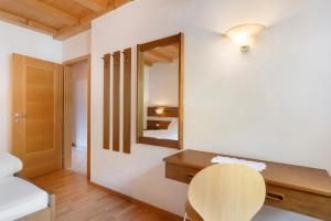 a room with a mirror and a table and a bed at Hofanger in Lagundo +98 photos