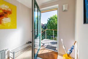 a room with a glass door leading to a balcony at Sonnenhaus am See in Schwerin