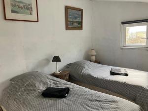 a bedroom with two beds and a black bag on the bed at Les Chalets de Babeth et Cathy in Trouan-le-Grand