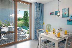 a dining room with a table and chairs and a patio at Seeart-apartment No 86 in Ludwigshafen