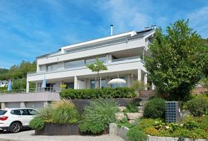 a white car parked in front of a house at Seeart-apartment No 86 in Ludwigshafen