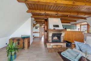 a living room with a fireplace and wooden ceilings at Fernblick in Behrensdorf