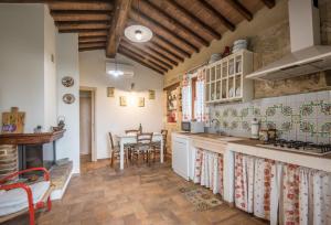 a kitchen with a table and a counter top at Appartamento Capannina in Lucciana +20 photos
