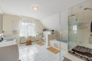 a bathroom with a shower and a sink and a tub at Fernblick in Behrensdorf +26 photos