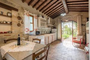 a kitchen with a table and chairs and a room at Appartamento Capannina in Lucciana