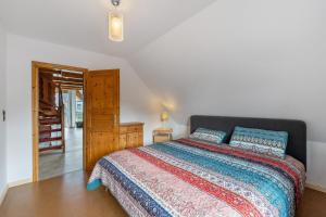 a bedroom with a large bed and a wooden cabinet at Fernblick in Behrensdorf
