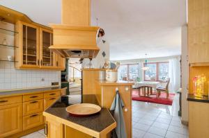 a kitchen with wooden cabinets and a counter top at Schwarzwalduhren Nescht Triberg in Triberg +24 photos
