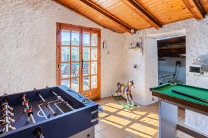 a play room with a pool table and toy dolls at Masia Can Vilar in Maçanet de la Selva