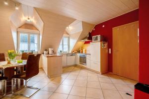 a kitchen with a white refrigerator and a table at Ferienwohnung Katharina in Laufeld +19 photos