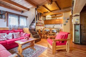 a living room with a red couch and a table at La Baita Verde in Motta