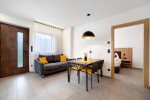 a living room with a table and a couch at Haus Nummer 9 in Marlengo