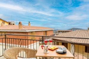 a table with two glasses of wine on a balcony at Jerzu Centro 2 in Jerzu