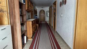 a hallway with a red stripe on the floor at Birkenhof in Leutasch