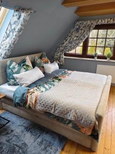 a bed sitting in a room with windows at Ferienhaus Wurzinger in Mureck