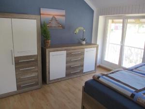 a bedroom with a bed and a dresser and a dresser at Fewo 1 - Osterberg in Liebenau
