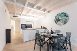a kitchen and dining room with a table and chairs at Aa Imbarcadero apartments in Salò