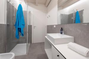 a white bathroom with a sink and a shower at Aa Imbarcadero apartments in Salò +125 photos