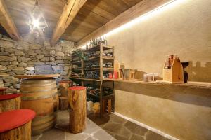 a bar in a wine cellar with a bunch of wine bottles at Haus Nummer 9 in Marlengo +37 photos