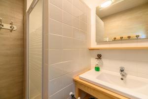 a bathroom with a sink and a shower at Chalet Les Airelles in Mittlach +20 photos