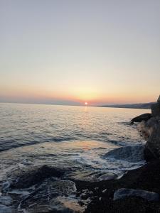 a sunset over a body of water at Casa Azzurra 56 in Bova Marina