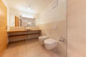 a bathroom with a toilet and a sink at Naturoase Stegerhof Apt Iris in Trodena +27 photos