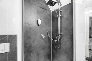 a shower with a glass door in a bathroom at Appartement am Kirnbergsee in Bräunlingen +20 photos