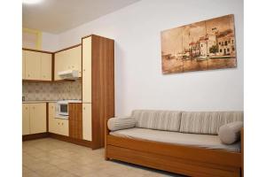 a living room with a couch and a kitchen at Manolika Studio 5 in Kithnos