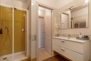 a bathroom with a sink and a shower and a mirror at Casabb in Toscolano Maderno +60 photos