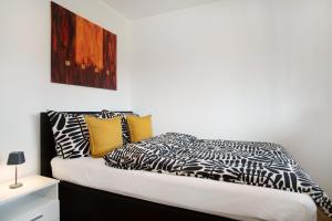 a bedroom with a bed with black and white pillows at Ferienwohnung am Bodensee in Bregenz