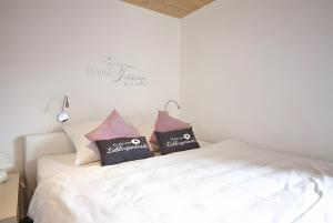 a bedroom with a white bed with two pillows at Charmingsuite in Bad Teinach-Zavelstein