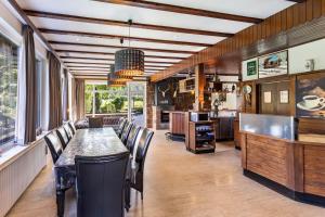 a dining room with a long table and chairs at Zum Holzknecht in Willingen