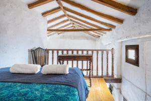 a bedroom with a bed with two pillows on it at Buhardilla La Prensa in Sorvilán