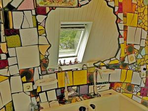 a bathroom with a mirror and a sink at Ferienwohnung Mulleby in Süderhackstedt +23 photos