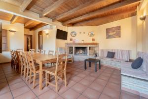 a dining room with a table and a fireplace at La Posada in Chera
