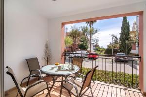 a patio with a table and chairs on a balcony at O'pomar 150 in Tavira