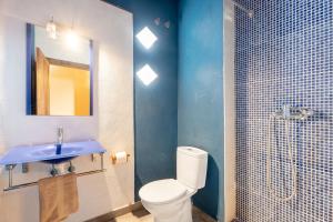 a bathroom with a toilet and a sink and a shower at La Posada in Chera +29 photos