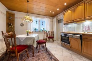 a kitchen with a table and chairs in a room at Fewo Kaiser in Südbrookmerland